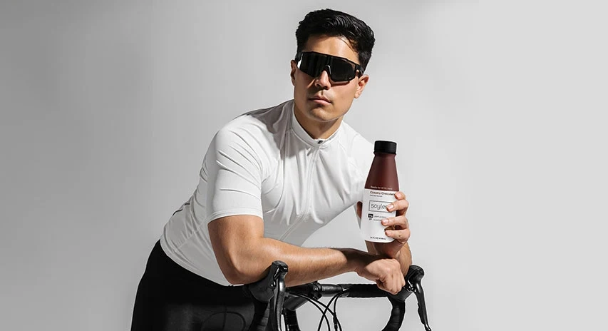 A Soylent complete meal shake next to its ingredients