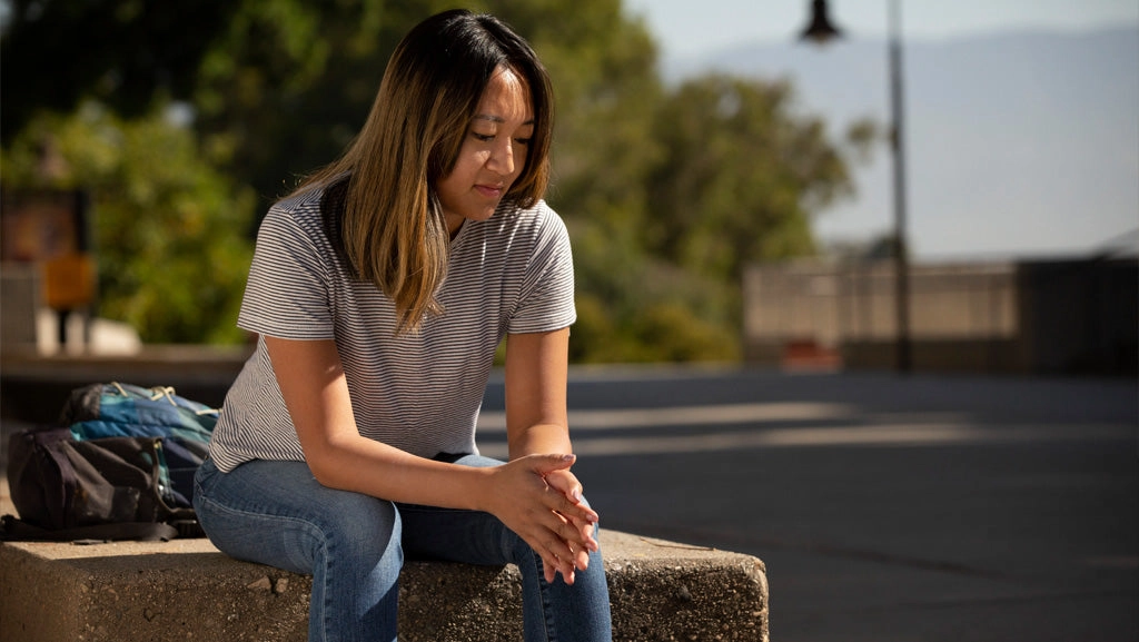 Hungry student sitting on campus